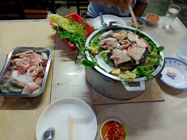Hands preparing a salad with leafy greens
